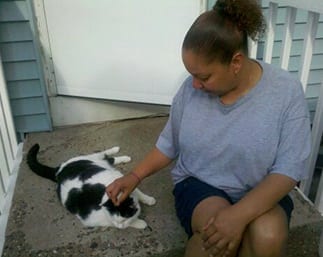 girl petting white and black cat